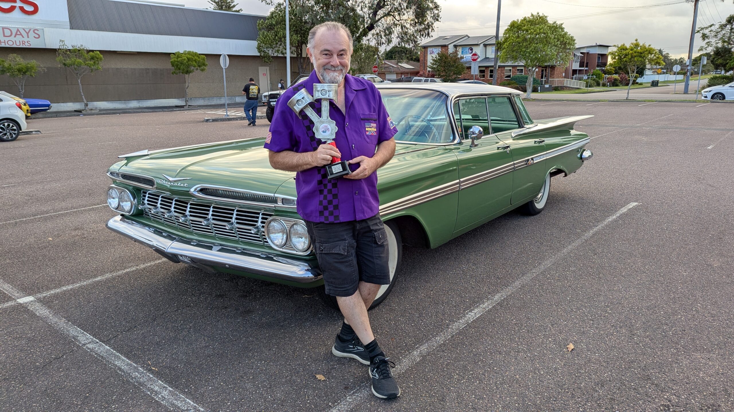 A photo of Simon, the IT GP, winning an award for his 1959 Chevrolet car